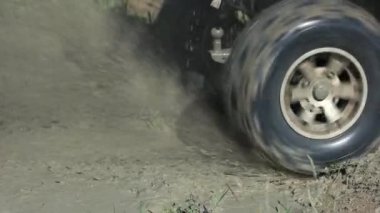 Motion of the wheel tire in a dirt with water.
