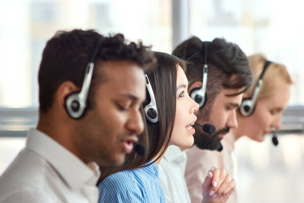 Young asian girl working as call center operator.