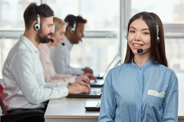 Portrait of smiling japaneese girl with headset in call center office. — Stock Photo, Image