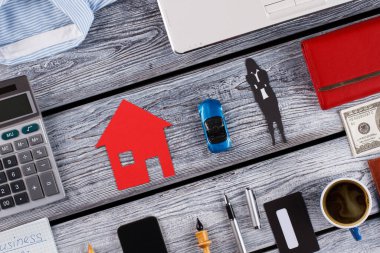 Calculator, models of house and car.