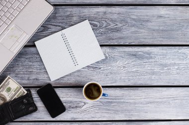 Laptop, planner, black purse and coffee.