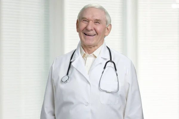 Old cheerful doctor is laughing. — Stock Photo, Image