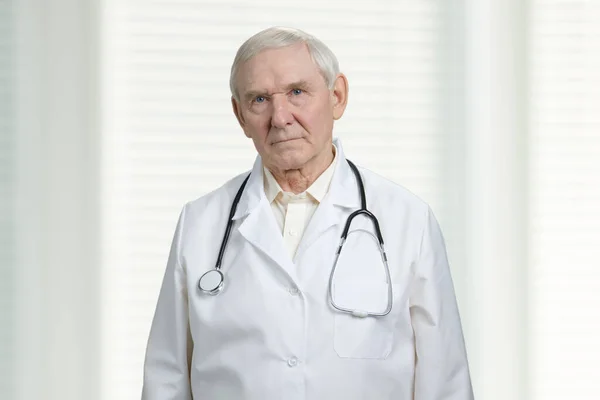 Gloomy male senior doctor portrait. — Stock Photo, Image