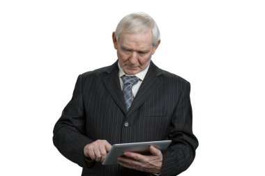 Old businessman using tablet.