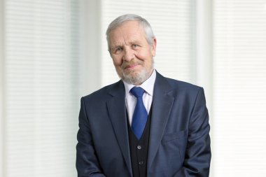 Smiling old man in suit portrait.