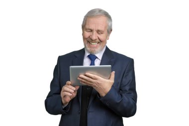 Senior man laughing watching on tablet.
