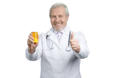 Senior doctor with orange can of pills and thumb up.