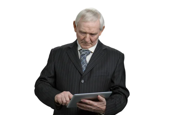 Old businessman using tablet. — Stock Photo, Image