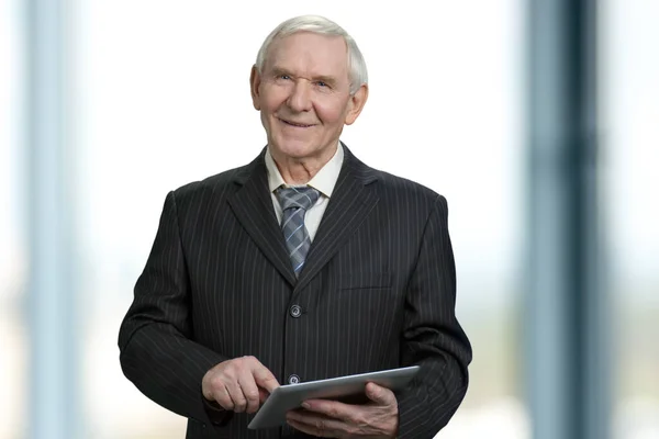 Senior businessman touching tablet screen. — Stock Photo, Image