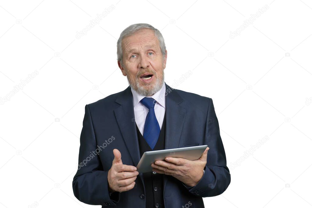 Old businessman talking, holding tablet.