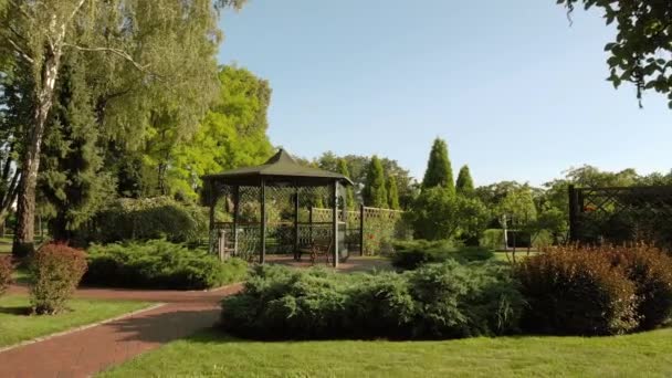 Garden gazebo with bench. — Stock Video