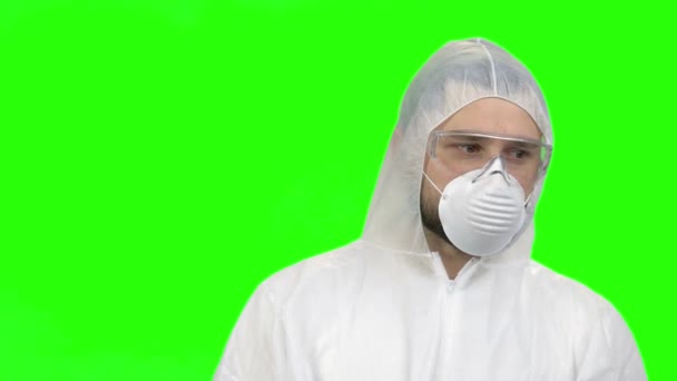 Portrait of young man wearing protective suit and medical mask for respiratory protection. — Stockvideo