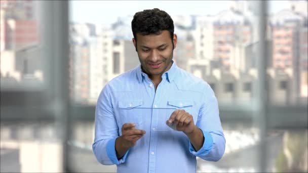 Young indian man using blank transparent tablet. — Stock Video