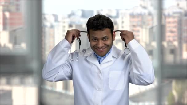 Porträt eines fröhlichen indischen Arztes mit Stethoskop. — Stockvideo