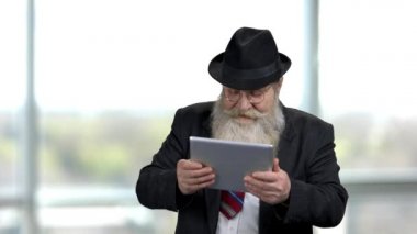 Tabletli heyecanlı yaşlı adam.