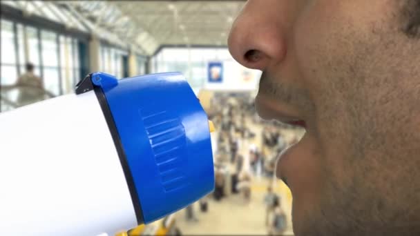 Extreme closeup brown-skinned man talking in megaphone. — Stock Video