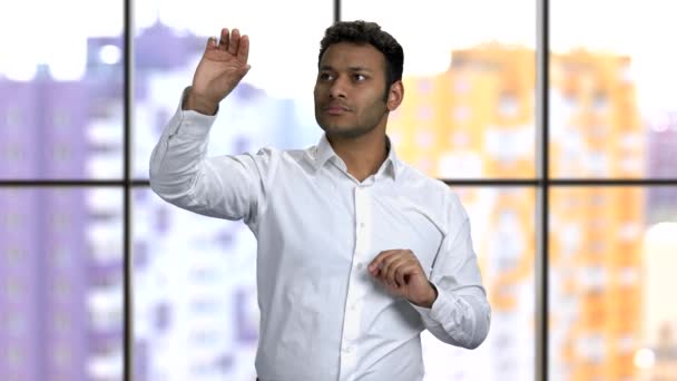 Portrait of dark-skinned man touching huge virtual screen. — Stock Video