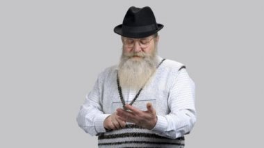 Yaşlı sakallı adam cam kaydırıyor ve kaydırıyor. Şeffaf kopya uzay tableti..