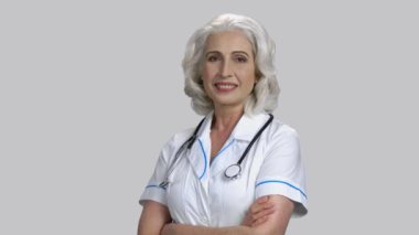 Kollarını kavuşturmuş yaşlı bir kadın..