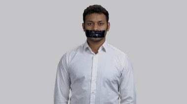 Koyu tenli, ağzı bantlı Hintli adamın portresi..
