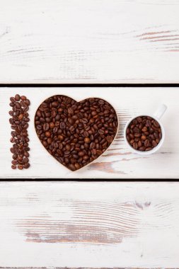 Taze kavrulmuş kahve taneleri formda dizilmiş..