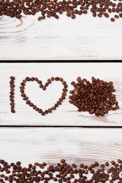 Roasted coffee beans in a shape of letter I and heart.