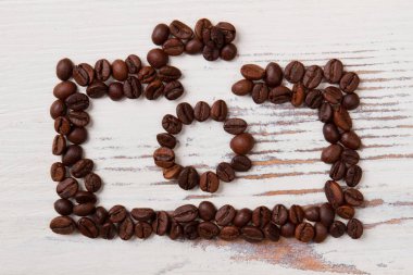 Fotoğraf makinesi beyaz tahtadaki kahve çekirdeklerinden yapılmış..