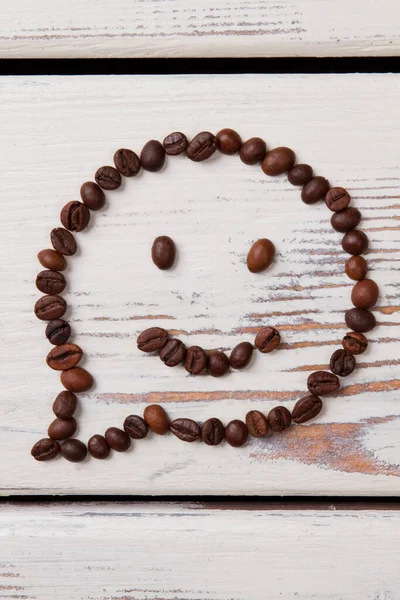 Smile face emoticon bubble talk made of coffee beans.
