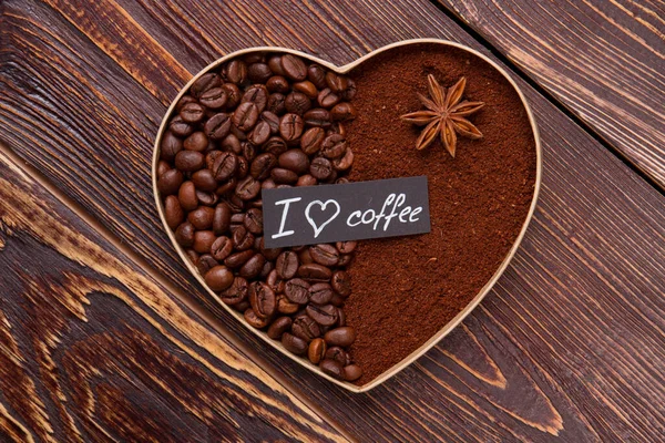 Close up decorative coffee heart on wooden table.