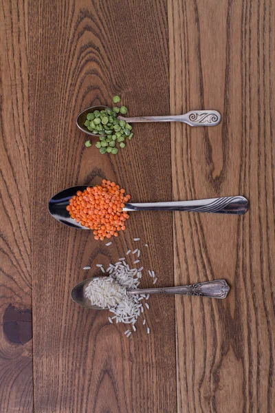 Three teaspoons with different grains. — Stock Photo, Image