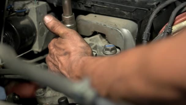 Автомеханик, работающий над автомобильным двигателем в гараже механики. — стоковое видео