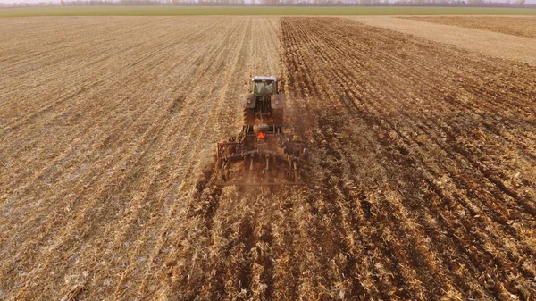 Tractor plowing field after harvesting. — Stock Photo, Image