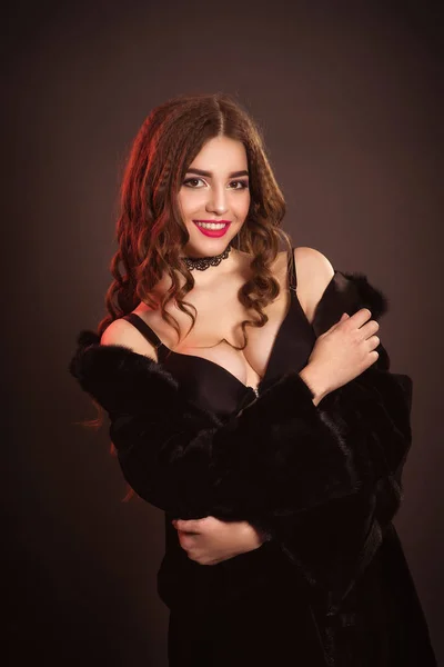 Belle femme sexy aux cheveux longs en lingerie noire portant un manteau de fourrure — Photo