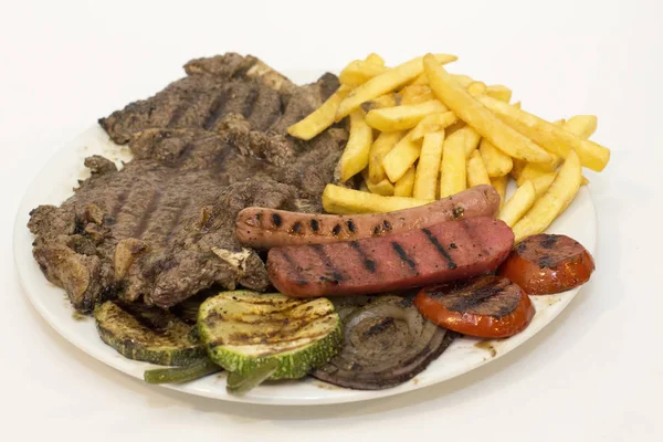 Grilled beef steak with sausage, mixed grilled vegetables. — Stock Photo, Image