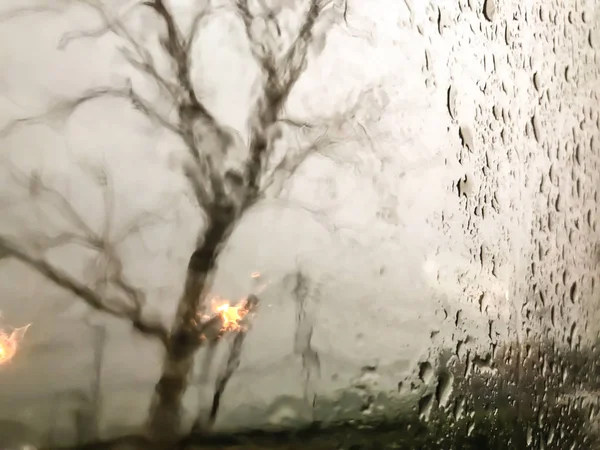 Regentropfen, Straßenansicht durch Autoscheibe verschwommen mit Regen, Drivin — Stockfoto