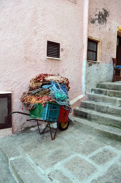 Fishing net in old wheelbarrow in the street — Stock Photo, Image