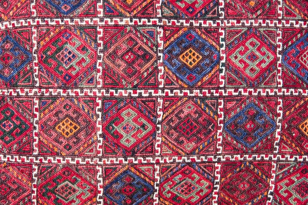 Bright, colorful Turkish fabrics, bedspreads and kerchiefs with different oriental patterns. The texture of the textile or fabric, macro. Tissue, textile, cloth, material, woven.