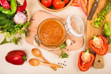 Domates sos (ketçap, adzhika) ve sebze bej bir tablo. Ev koruma.