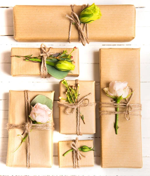 Blütenkomposition. Blumen und Geschenke auf weißem Hintergrund. flache Lage, Draufsicht. — Stockfoto