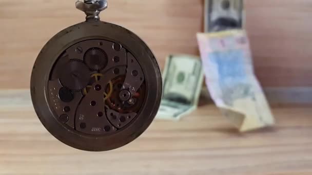 Le temps c'est de l'argent. L'horloge tourne sur fond de billets de monnaie — Video