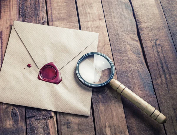 Envelope and magnifier — Stock Photo, Image