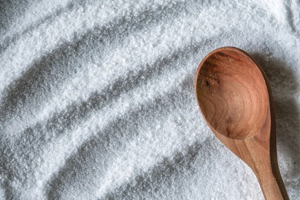 Salt background with wooden spoon — Stock Photo, Image