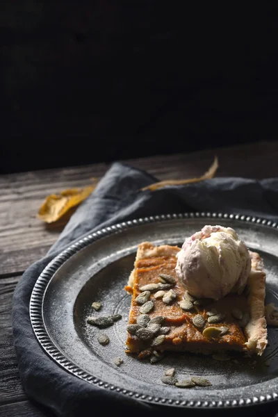 Slice of pumpkin pie with ice cream on the metal plate vertical — Stock Photo, Image