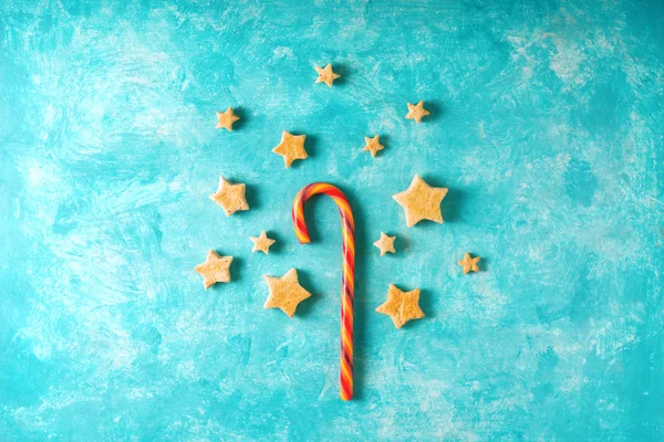 Christmas candy and cookies on the blue background top view — Stock Photo, Image