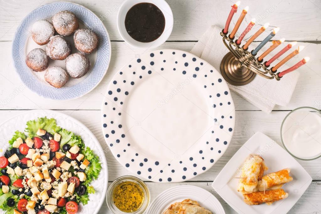 Traditional Hanukkah  dishes on the white wooden table  horizontal