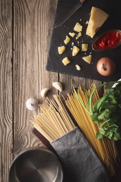 Ingrediënten voor het koken van spaghetti met kaas en verse kruiden op de oude tabel — Stockfoto
