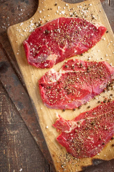 Fresh beef steak and spicel on board — Stock Photo, Image