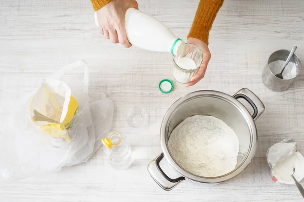 Woman prepares dough pizza on the white table — Stock Photo, Image