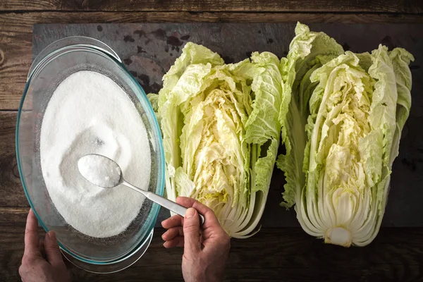 Salt, the two halves of Chinese cabbage to cook kimchi on slate — Stock Photo, Image