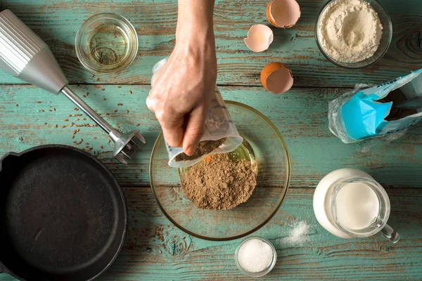 Adding flour in  glass bowl for cooking pancakes top view — Stock Photo, Image